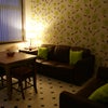 Photo 2: The living area with the main light off and lamp on