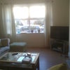 Photo 3: Front room with TV
