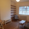 Photo 4: Double Aspect Living room with sofa, table, chairs & shelving