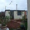 Photo 3: Garden (ground prepared for seed / new turf, temp fence to keep dogs off!)