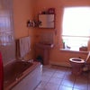 Photo 3: Bathroom which has bath with shower over