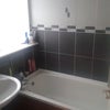 Photo 3: bathrrom has shower above bath