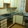 Photo 3: Kitchen with washing machine, microwave and storage