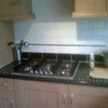 Photo 3: gas hob, electric oven, microwave, cupboard to keep own items, sink and washing machine