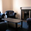 Photo 3: Living room now with new sofas, a dining tale, and large flatscreen TV mounted onto wall