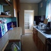 Photo 2: The kitchen with living room behind