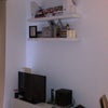 Photo 4: Here is the communal TV! And the floating shelves 