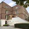Photo 6: Exterior of building - flat is the row of windows above porch. Parking space is where photo is taken