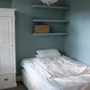 Photo 2: Storage in bed drawers, wardrobe and shelves. More storage outside the room