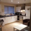 Photo 2: Modern fully fitted kitchen with breakfast bar and stools 