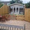 Photo 8: Elevated, sun trap garden with summerhouse containing sofa bed and power.