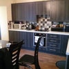 Photo 2: kitchen + laundry room at back