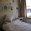 Photo 7: Bed and bedside table in room
