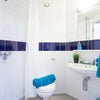 Photo 5: Cute, functional toilet with shower. Very easy to keep clean
