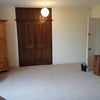 Photo 6: Through the double doors in room 5 is a large storage area with shelving.