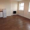Photo 2: Sitting room and kitchen