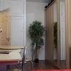 Photo 2: There are a spacious wardrobe with big mirrors. The book shelves and a decorative plant are in the r