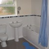 Photo 4: Bathroom with Shower over Bath, Wash Basin, Toilet and Storage Unit