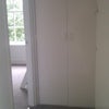 Photo 5: Entrance into flat, showing hallway with built-in cupboard for coats etc. Bathroom is on right as yo