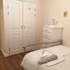 Photo 2: This is the other end of the room taken from the window, including a built-in wardrobe.