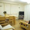 Photo 9: Living room with sofa, table and wall mounted flat panel TV