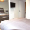 Photo 4: Each room has a huge wardrobe, a fold down desk & a television,