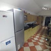 Photo 4: Two large fridge/freezers are shared between four tenants and ample cupboard space is provided.