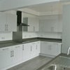 Photo 5: Modern kitchen with designated cupboard space for each tenant