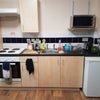 Photo 2: Kitchen area is on the right side of the room.