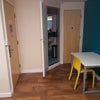 Photo 5: To the left is the door out. Straight forward - the bathroom.