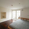 Photo 2: Bedroom/Living Room - Cooking appliances within concealed storage.