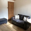 Photo 5: Living room with seating, TV & dining table