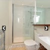 Photo 2: Contains standing shower, towel heater and large mirror.