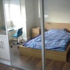 Photo 5: A view of the large mirrored wardrobe with the bed in the reflection.  Space for a desk in bay.