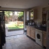 Photo 1: Kitchen with sliding doors onto the garden