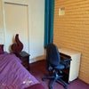 Photo 4: Turquoise curtains are in front of shelving and wardrobe hanging space.