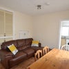 Photo 4: TV room with leather sofa dining table & chairs