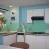 Photo 5: There is a large kitchen