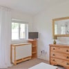 Photo 7: Table, chest of drawers and TV