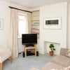 Photo 4: downstairs tv sofa area