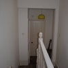 Photo 5: Top landing showing door into bedroom