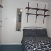 Photo 2: There is a double bed & lots of shelves