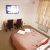 Photo 2: Double bedroom - bed, TV and window view 