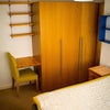 Photo 5: Lots of storage. Bed high enough for suitcases to slide under