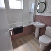 Photo 4: Stylish Bathroom on the First Floor.....