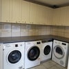 Photo 6: There is an external laundry room with a locked cupboard for each room