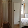 Photo 4: walk-in wardrobes behind the bed 