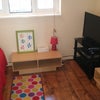 Photo 8: Shared living space (book case and DVD cabinet behind the door)