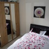 Photo 5: The Garden view bedroom with ottoman bed, mahoosive wardrobe, and desk.