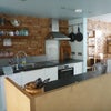 Photo 2: Central open plan kitchen facing shared dining are